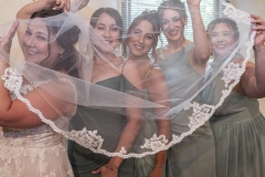 Bride-with-bridesmaids-under-veil