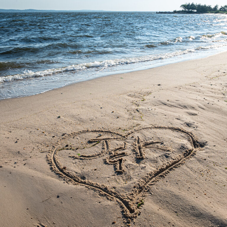 Kaylan and Joe Engagement picture initials in the sand at Sandy Hook Beach, NJ