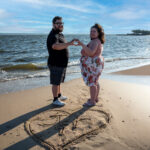 Kaylan and Joe Engagement picture with initials in the sand at Sandy Hook Beach, NJ
