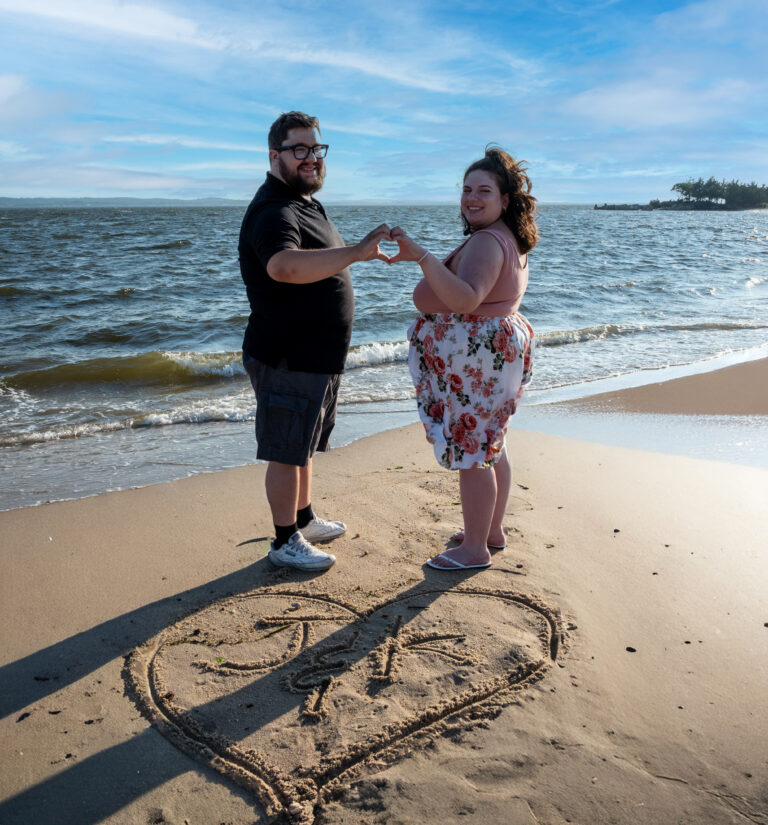 Kaylan and Joe Engagement picture with initials in the sand at Sandy Hook Beach, NJ